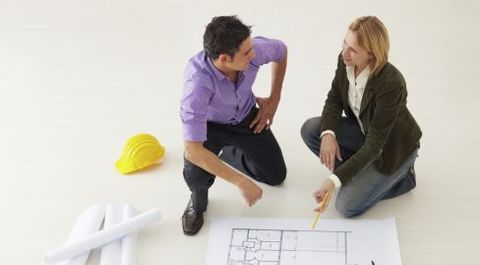 Woman checking blueprint with one of the building designers in North Hobart