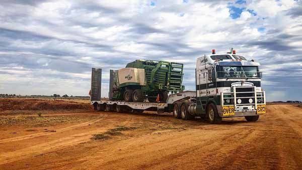 truck hauling vehicle on dirt road