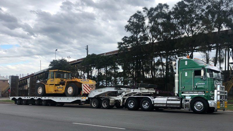 green truck towing car
