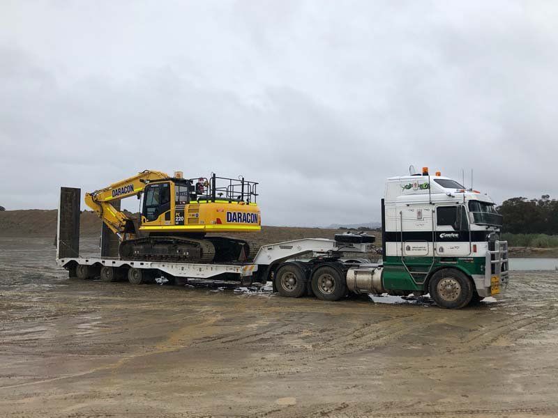 truck haling construction equipment