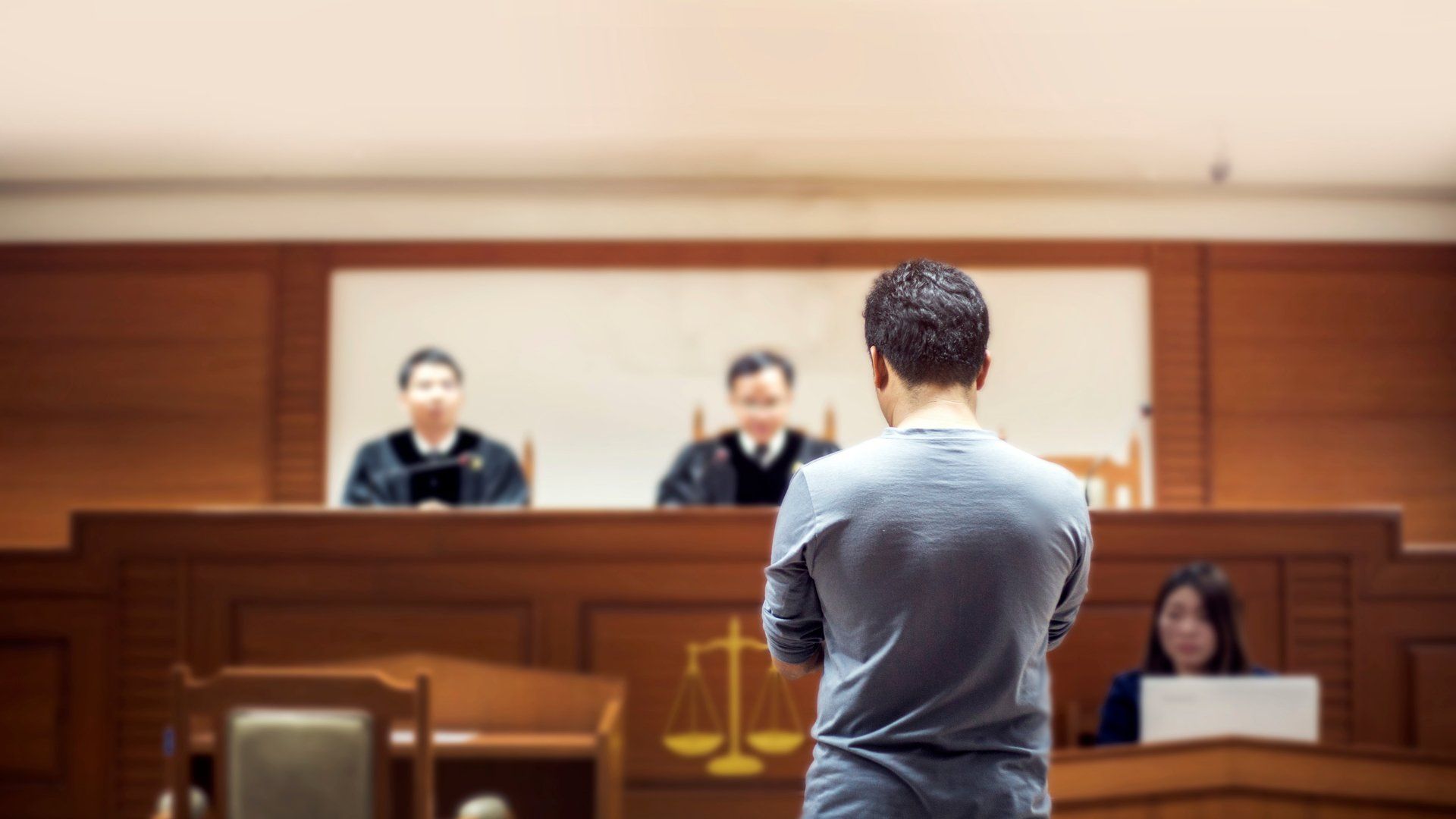 A man standing in front of a judges bench