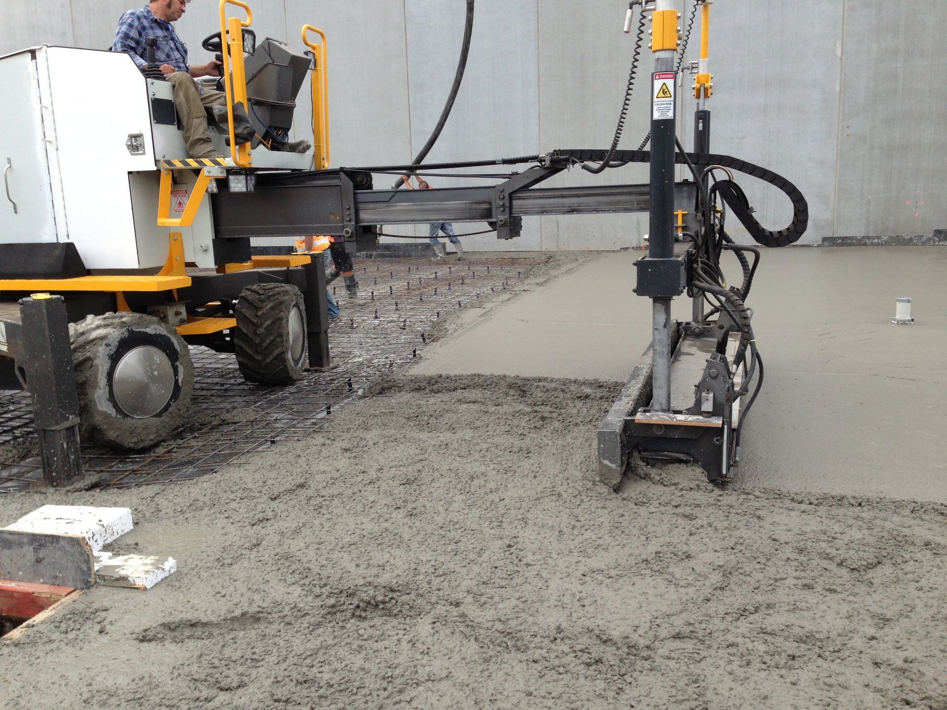 Concrete truck spreading and flattening