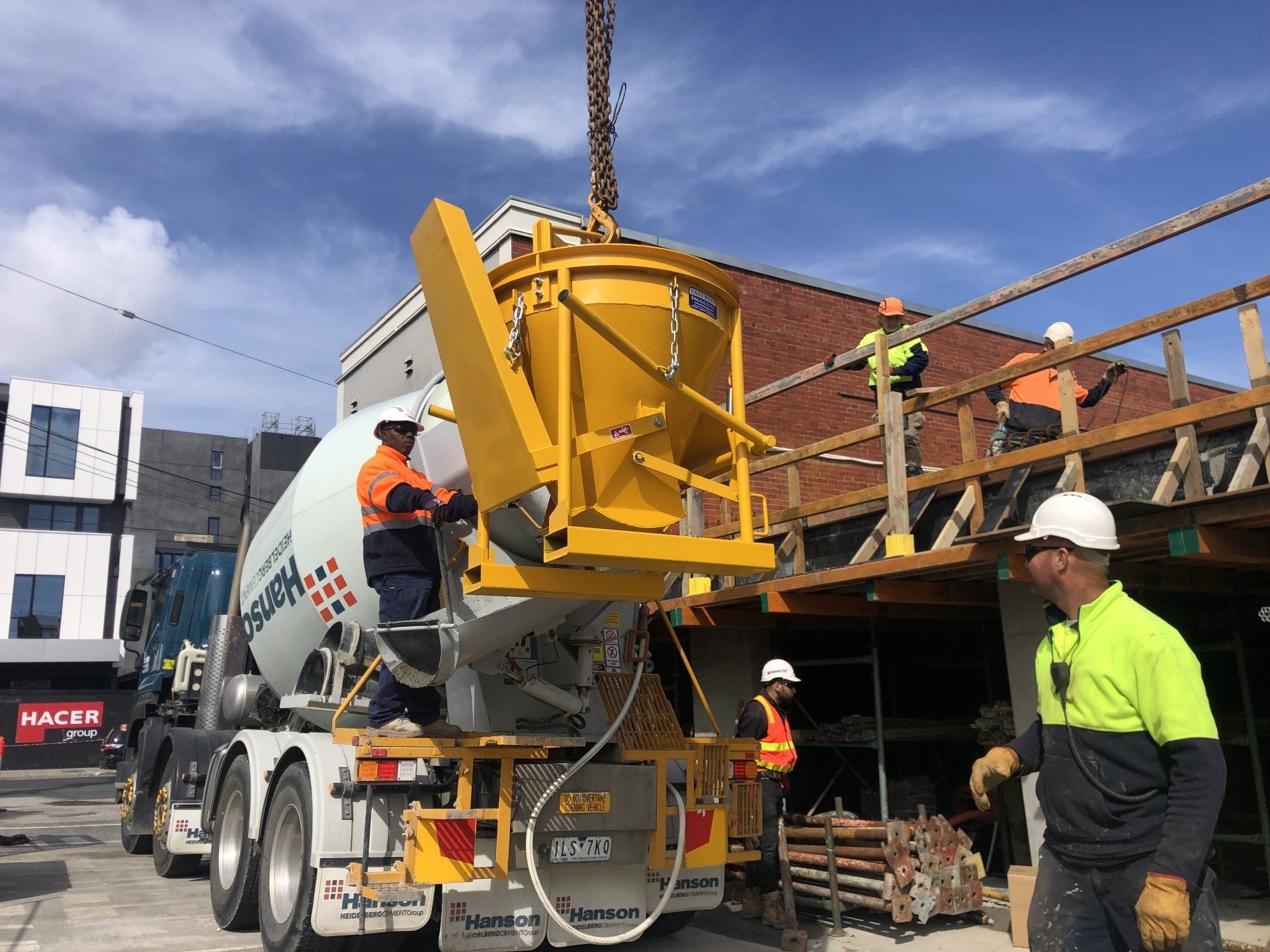 workers on concrete mixer trailers