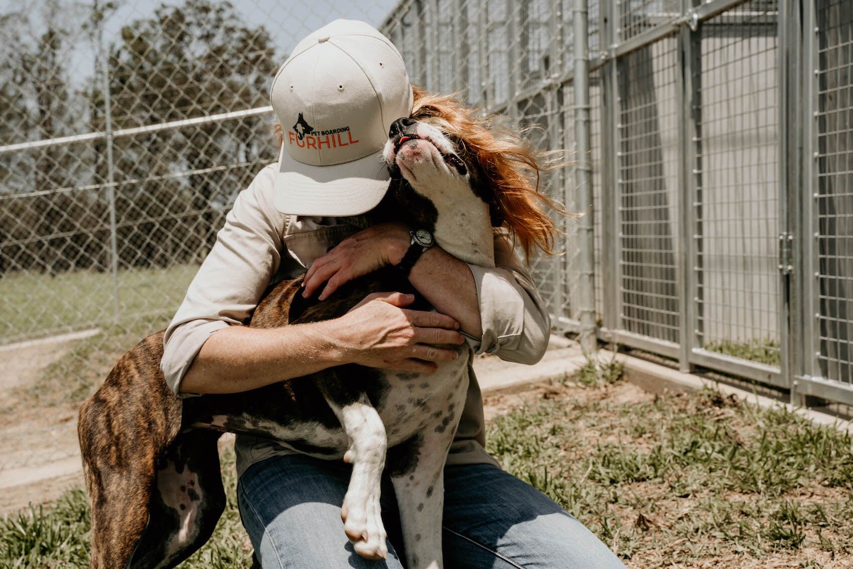 Man Hugging Dog — Furhill Pet Boarding in East Kempsey, NSW