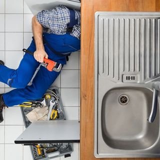 plumber under sink