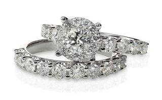 two white gold and diamond engagement rings stacked
