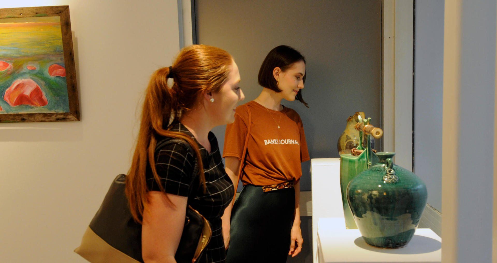 Women looking at porcelain vases