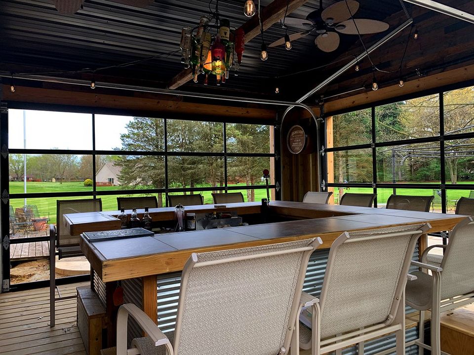 Garage Doors Turn Poolside Bar into Year-Round Retreat that Serves as