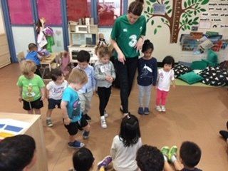teacher standing with class while teaching