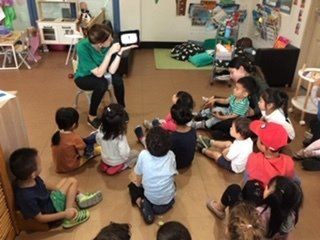 teacher sitting while teaching