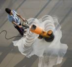 A woman using cleaning chemicals on a South East Queensland floor