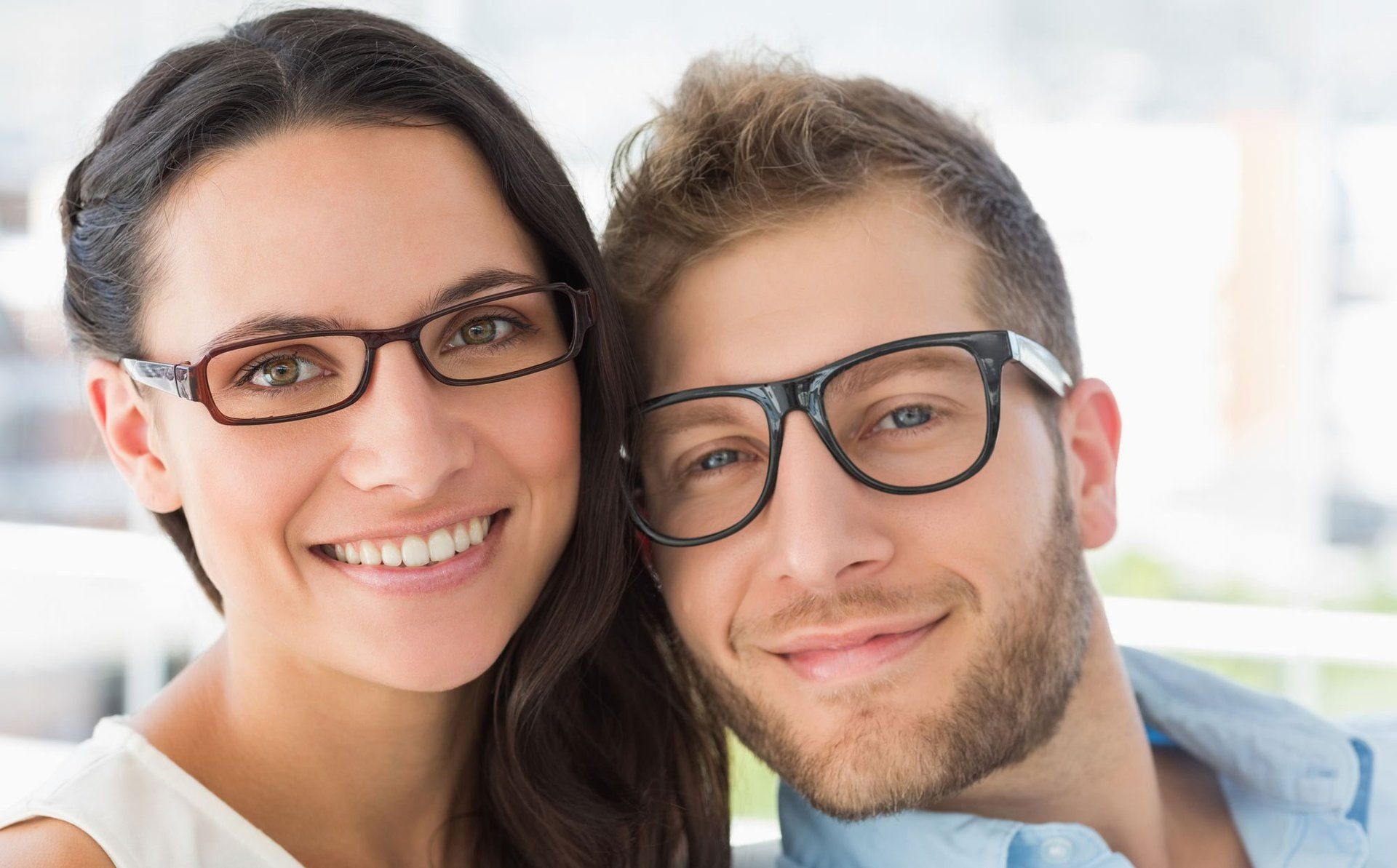 women and man faces with black glasses