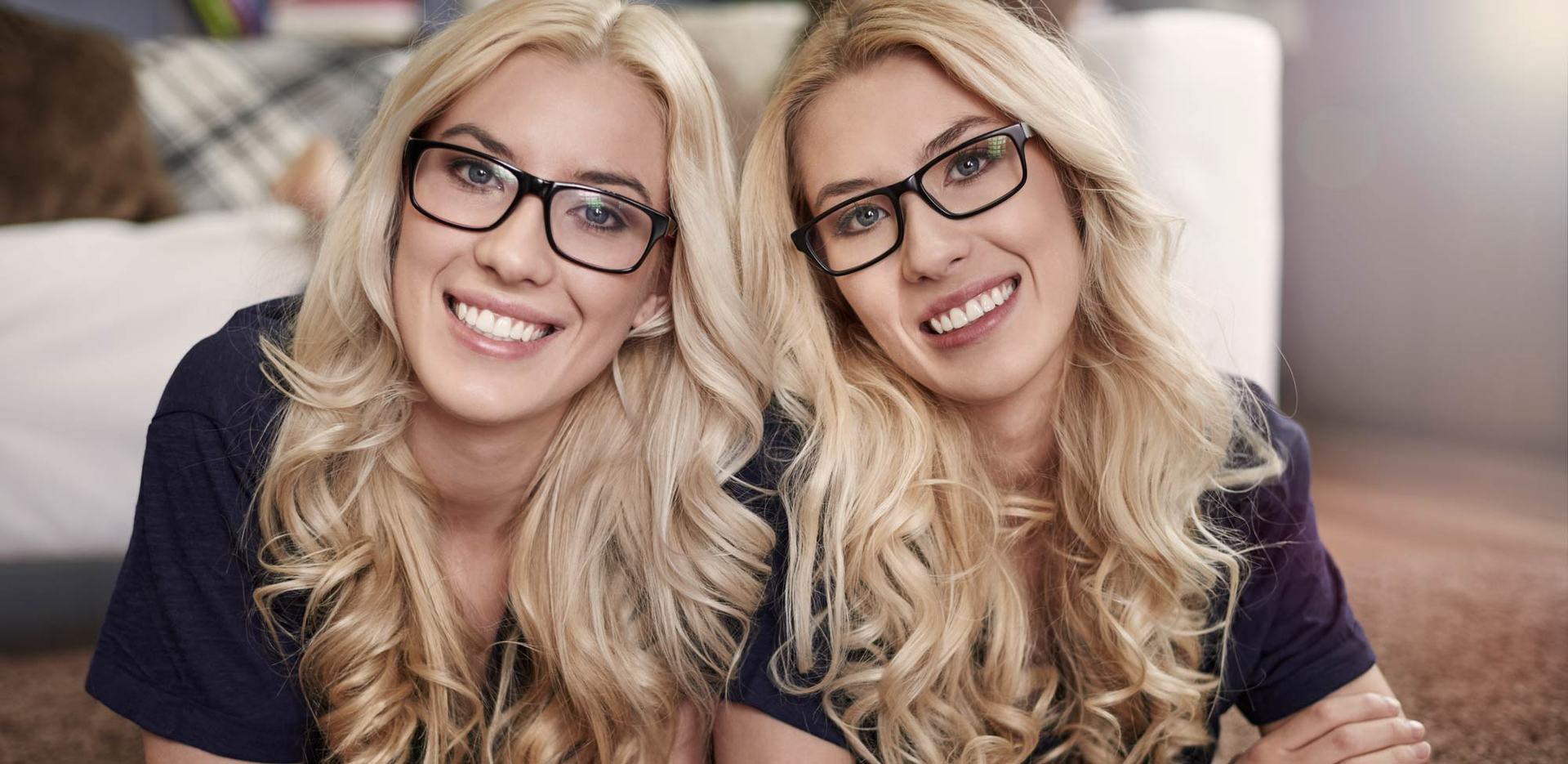 2 blonde ladies with black framed glasses