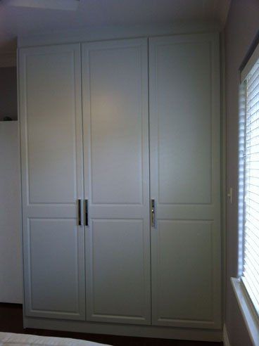 three tall vertical vinyl wrap hinged doors