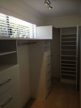 walk in wardrobe with small blinded window