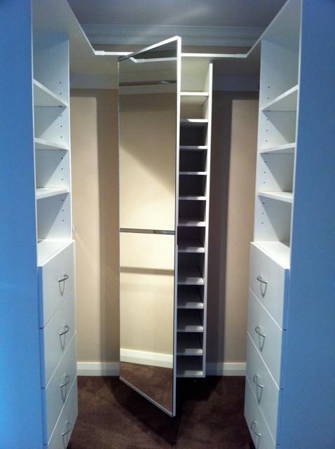 white internal shelving for walk in wardrobe including shoe storage