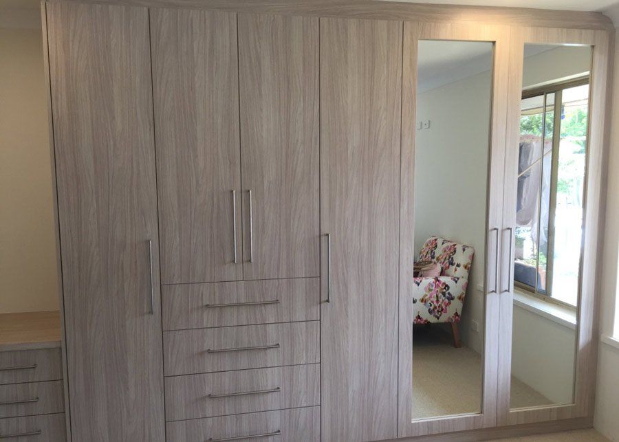 light brown multiple shelved and mirrored wardrobe