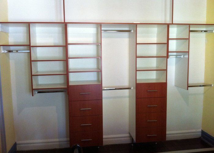 white internal shelving with coloured facia stacked along wall