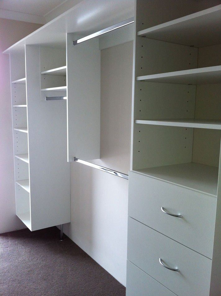 third view of white shelved walk in wardrobe