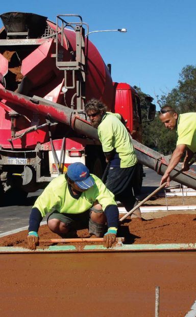 Men installing retaining walls and concrete kerbing in Bunbury