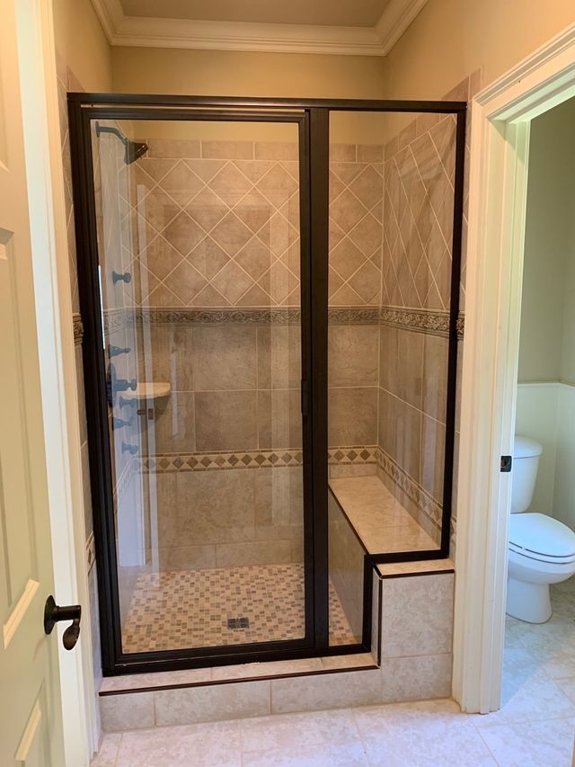 A Beautiful Frameless Shower Door Enclosure With Oil Rubbed Bronze Hardware C Pull And Towel Bar Comb Shower Doors Bathroom Tub Shower Frameless Shower Doors