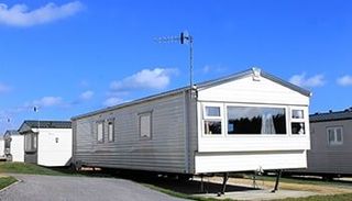 Caravan on a trailer park in summer - AZ Mobile Homes in Flagstaff, AZ