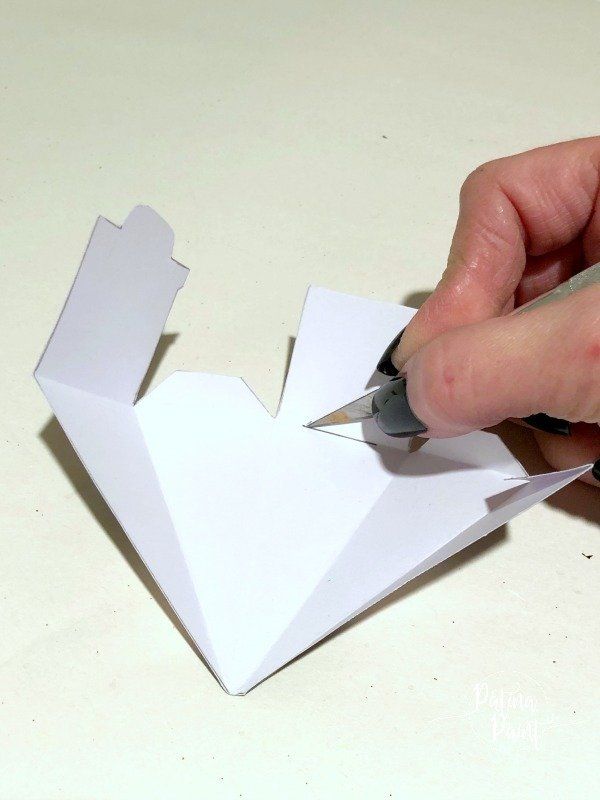cutting a slit in the box lid