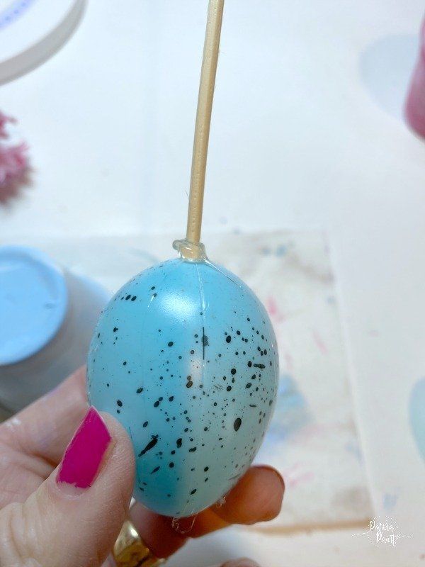plastic easter egg on a wooden skewer