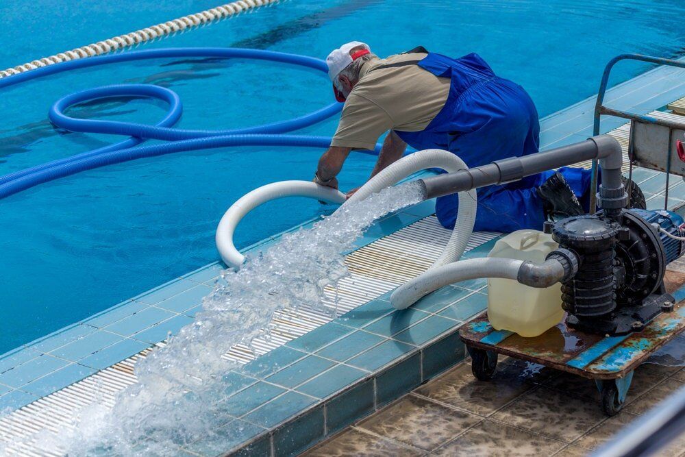 Worker Cleaning the Pool — Pool Services in Cessnock, NSW