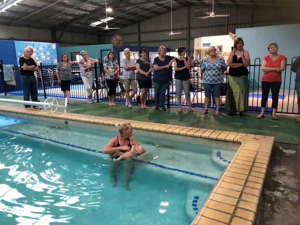 Right Holding of Infant in the Pool — Swim School in Barney Point, QLD
