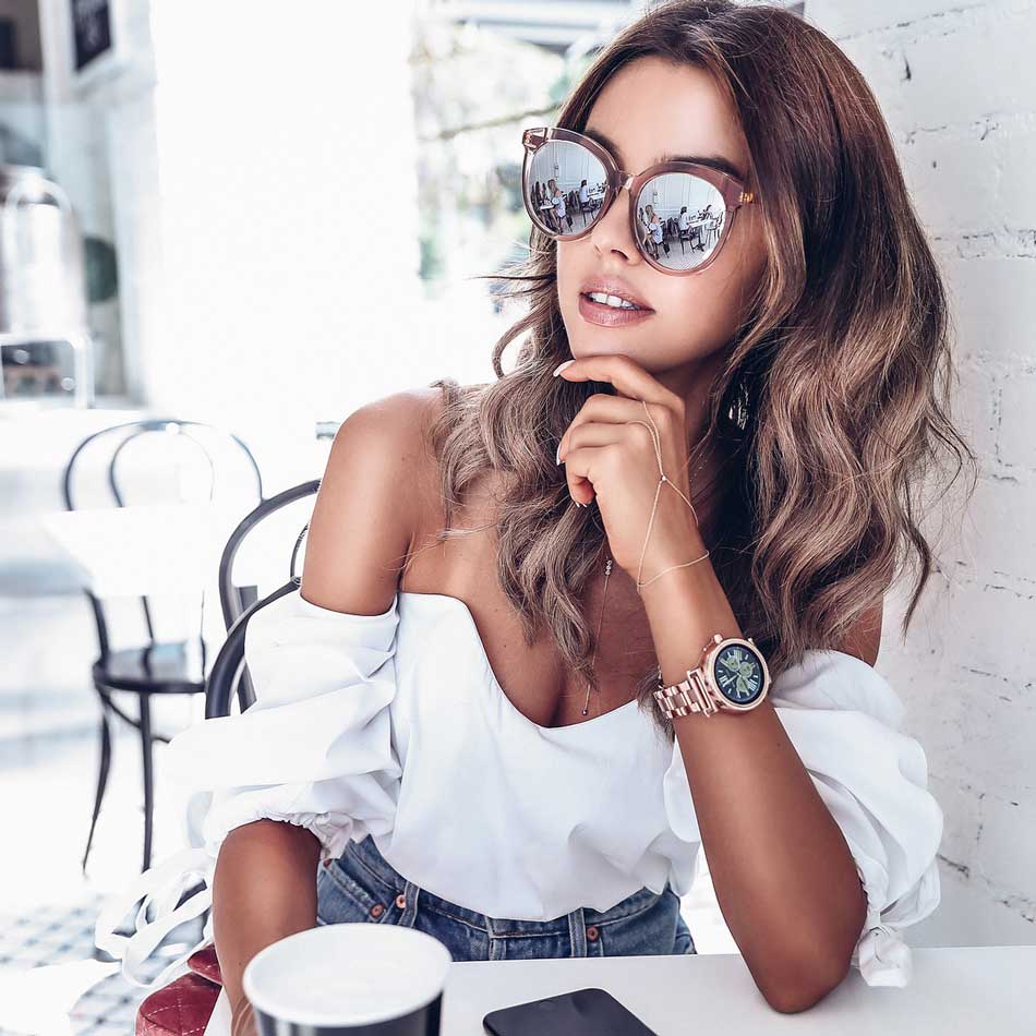 women at table in sunglasses