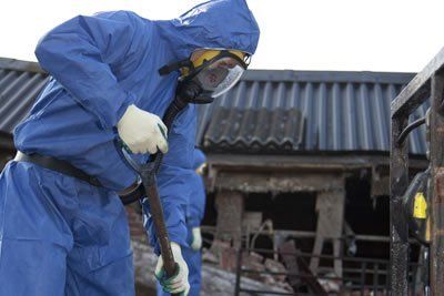 Fire damage clean up in progress. Fire damage remediation requires significant personal protection equipment.