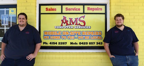 ams computer repair sign and employees