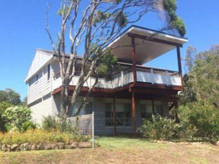 white house with awning above porch