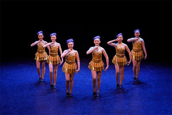 dancers wearing gold