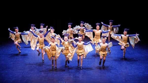 child dancers in gold outfits
