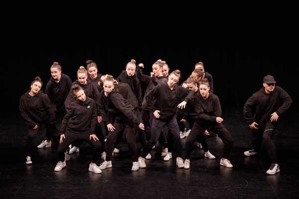 group of dancers in black
