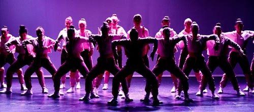 dancers on dark stage