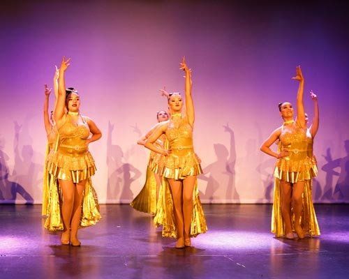 dancers in gold dresses