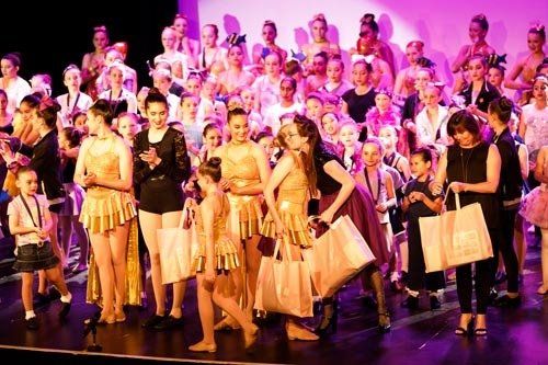 crowd of people holding bags