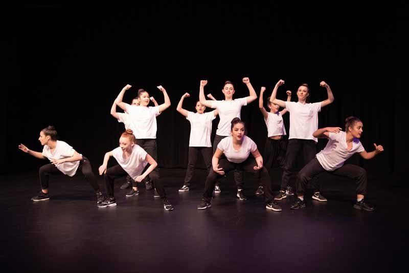 dancers posing with arms up