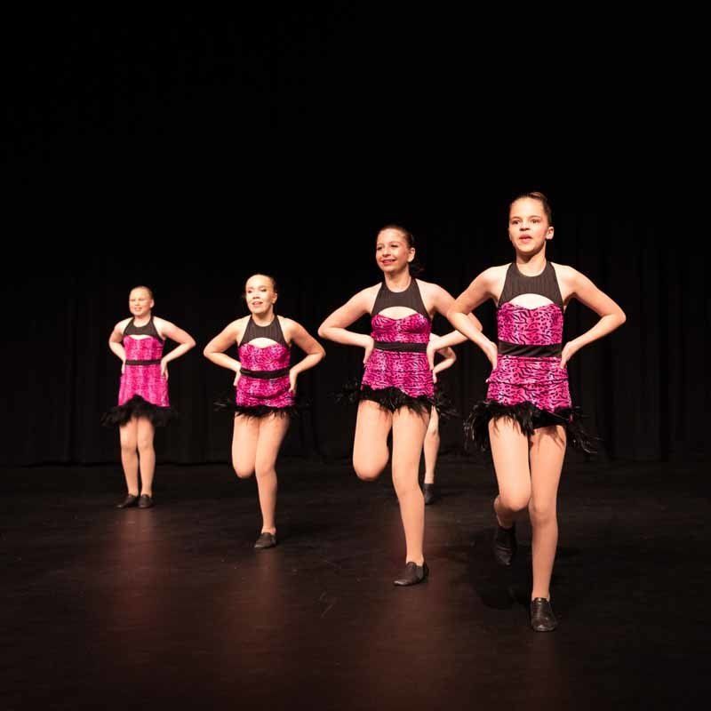 four dancing girls in pink