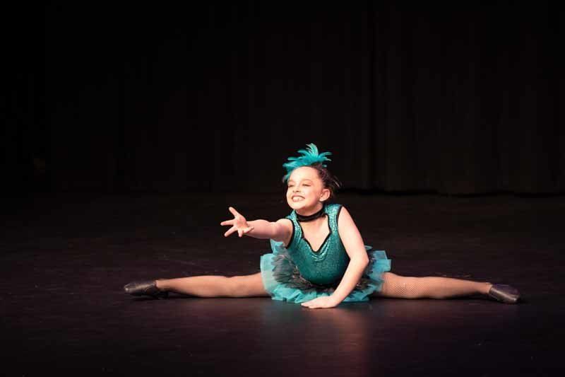 girl in blue dress reaching out