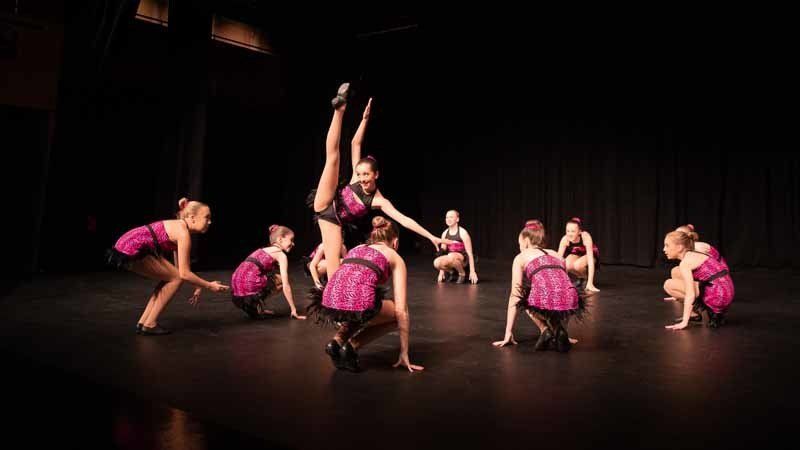 crouching dancers in pink