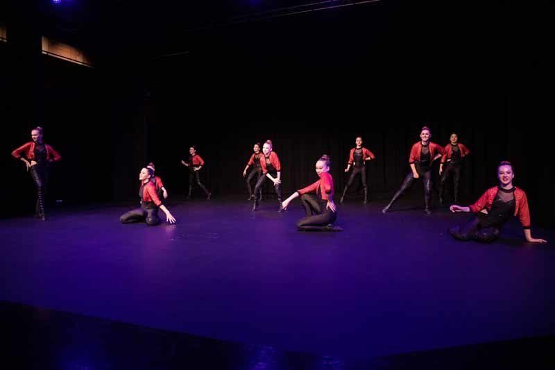 dancers sitting on purple floor