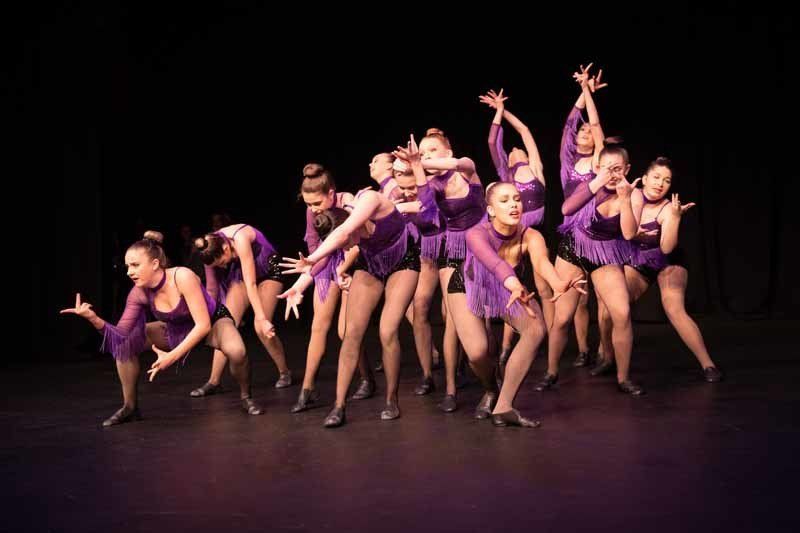 group of dancers wearing purple
