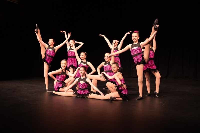 group of young dancers in pink and black
