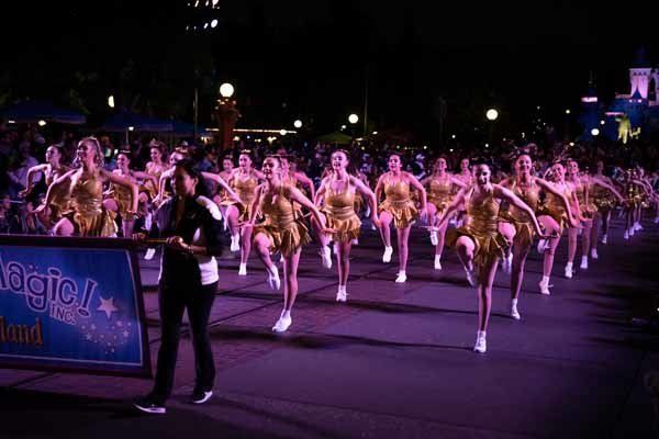 dancers in gold during parade at disneyland