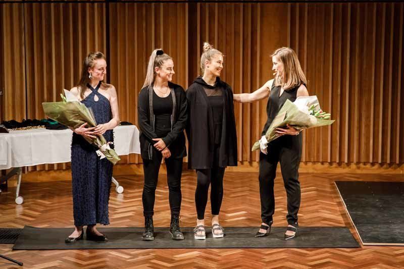 performers holding flowers