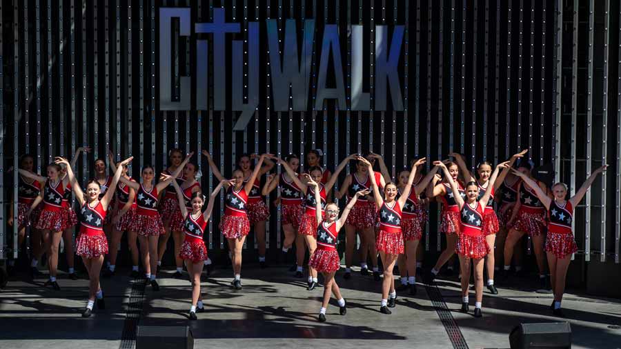large dance group in red on stage